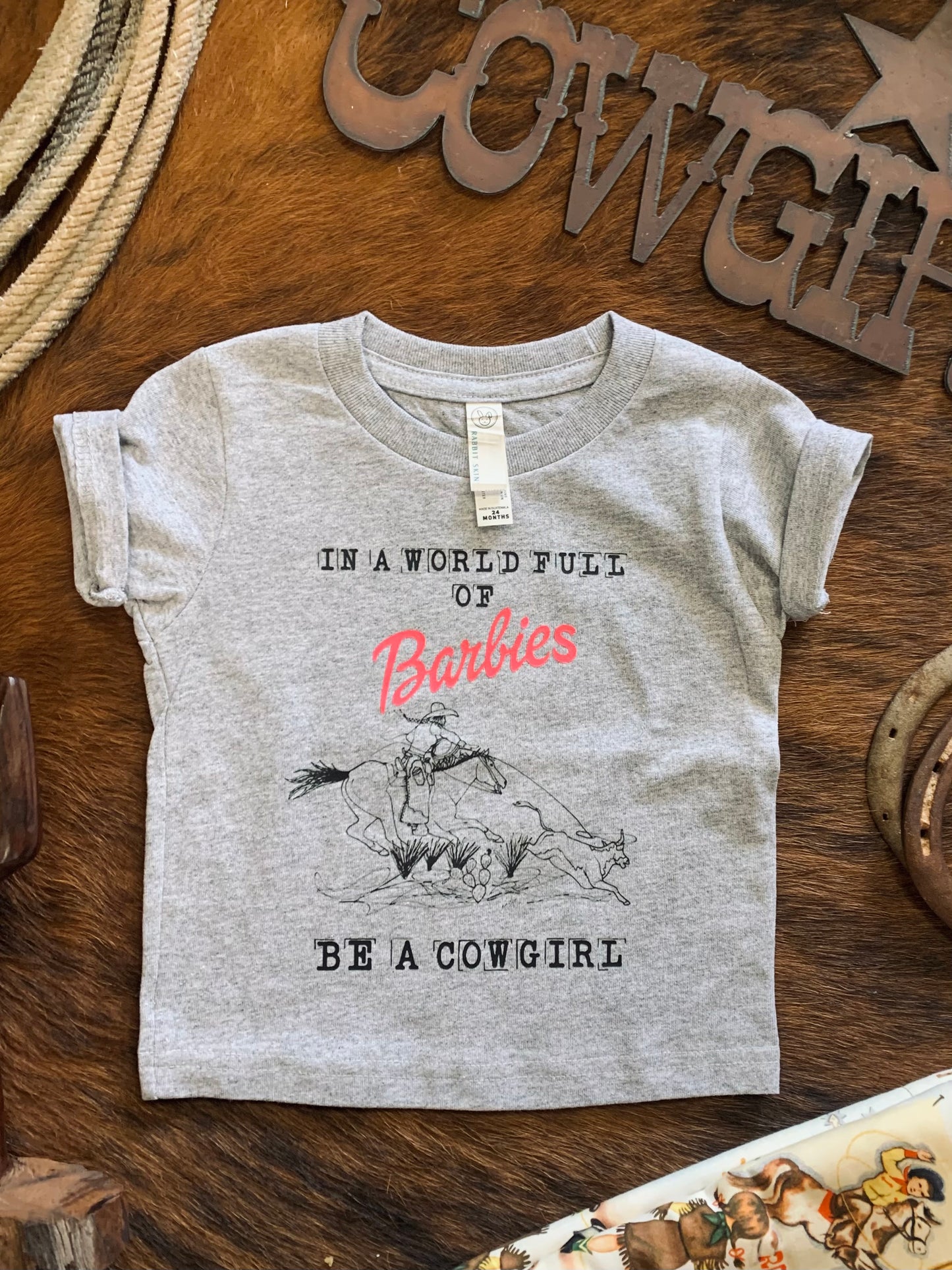 In A World Full of Barbies Be A Cowgirl Toddler Tee